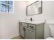 This updated bathroom has a vanity with a light green cabinet, white counter and a sleek faucet at 594 Waynes Se Ct, Atlanta, GA 30354