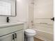 A relaxing bathroom with modern fixtures, a sleek vanity, and a bathtub with shower at 594 Waynes Se Ct, Atlanta, GA 30354