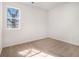 This bedroom features neutral carpet, white walls, baseboards, and a window at 594 Waynes Se Ct, Atlanta, GA 30354