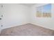 This bedroom features neutral carpet, white walls, a baseboard, and a window for natural light at 594 Waynes Se Ct, Atlanta, GA 30354