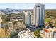Aerial view showcases the high-rise building within a vibrant, green landscape and city skyline at 799 Hammond Dr # 305, Atlanta, GA 30328