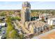 An aerial view shows a high-rise building with tennis courts and parking lot at 799 Hammond Dr # 305, Atlanta, GA 30328
