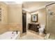 Elegant bathroom featuring a soaking tub, stone vessel sink, and separate glass enclosed shower at 799 Hammond Dr # 305, Atlanta, GA 30328