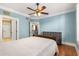 This bedroom features hardwood floors, shutters, a ceiling fan, and access to other rooms at 799 Hammond Dr # 305, Atlanta, GA 30328