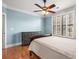 Comfortable bedroom with hardwood floors, shutters, and a ceiling fan at 799 Hammond Dr # 305, Atlanta, GA 30328