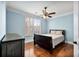 Comfortable bedroom with a ceiling fan, shutters, and hardwood floors at 799 Hammond Dr # 305, Atlanta, GA 30328