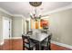 This dining area is adjacent to the kitchen and a doorway and has a decorative chandelier at 799 Hammond Dr # 305, Atlanta, GA 30328