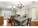 Cozy dining room featuring hardwood floors, a modern chandelier, and easy access to an outdoor patio at 799 Hammond Dr # 305, Atlanta, GA 30328