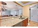 Open-concept kitchen offering granite countertops, stainless steel dishwasher, and dark-wood cabinets at 799 Hammond Dr # 305, Atlanta, GA 30328