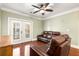 Comfortable living area features hardwood floors, double doors, and leather sofas at 799 Hammond Dr # 305, Atlanta, GA 30328