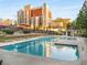 Resort-style community pool with sundeck, lounge chairs, and manicured landscaping at 799 Hammond Dr # 305, Atlanta, GA 30328