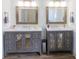 Bathroom with and grey vanities, each with mirror, sink, storage, and stylish lighting at 1931 Amber Dawn Way, Lawrenceville, GA 30043