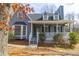 Charming home with a covered porch and a bay window adding character to the front exterior at 1931 Amber Dawn Way, Lawrenceville, GA 30043