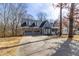 Two-story home featuring a stone and siding exterior with a three-car garage and covered front porch at 1931 Amber Dawn Way, Lawrenceville, GA 30043