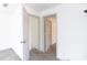 Hallway with doorways and neutral carpeting creating bright and open spaces at 1931 Amber Dawn Way, Lawrenceville, GA 30043