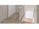 Hallway featuring carpet and railing leading to the staircase and the house's upper levels at 1931 Amber Dawn Way, Lawrenceville, GA 30043