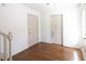 Hallway with hardwood flooring and doors, offering access to various rooms in the home at 1931 Amber Dawn Way, Lawrenceville, GA 30043