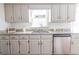 Kitchen area showcasing granite countertops, stainless steel dishwasher, and ample cabinet storage at 1931 Amber Dawn Way, Lawrenceville, GA 30043