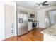 Well-lit kitchen featuring stainless steel appliances, granite countertops, and hardwood flooring at 1931 Amber Dawn Way, Lawrenceville, GA 30043