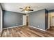 Bedroom with wood floors and ceiling fan, leading to a closet with built-in shelving at 2701 Cumberland Se Ct, Smyrna, GA 30080