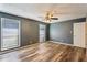 Bright bedroom offers wood floors, a ceiling fan, and plenty of natural light from two windows at 2701 Cumberland Se Ct, Smyrna, GA 30080