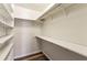 Walk-in closet with built-in shelves and wood-look flooring providing ample storage space at 2701 Cumberland Se Ct, Smyrna, GA 30080