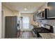 Updated kitchen features stainless steel appliances, granite countertops, and modern subway tile backsplash at 2701 Cumberland Se Ct, Smyrna, GA 30080