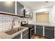 Galley kitchen featuring white subway tile backsplash, stainless steel appliances, and grey cabinets at 2701 Cumberland Se Ct, Smyrna, GA 30080