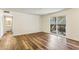 Living room featuring wood floors and a sliding door to the balcony, with bathroom access at 2701 Cumberland Se Ct, Smyrna, GA 30080