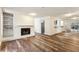 Bright living room featuring wood floors, fireplace, sliding doors to the balcony, and an open counter to the kitchen at 2701 Cumberland Se Ct, Smyrna, GA 30080