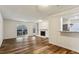Bright living room featuring wood floors, fireplace, sliding doors to the balcony, and an open counter to the kitchen at 2701 Cumberland Se Ct, Smyrna, GA 30080