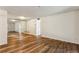 A spacious living room featuring wood floors, white walls and a wall mirror at 2701 Cumberland Se Ct, Smyrna, GA 30080
