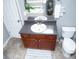 Bathroom vanity featuring dark cabinetry, a white sink, and granite countertops at 5895 Water Oaks Dr, Austell, GA 30106