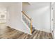 Bright entryway featuring hardwood floors, stairs with white railing, and natural light at 2215 Wildcat Cliffs Way, Lawrenceville, GA 30043