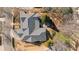 An aerial view shows the roof and patio of this home surrounded by mature trees at 4465 Newhall Dr, Cumming, GA 30040
