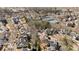 Aerial view of a residential neighborhood, showcasing lush landscaping, tennis courts, and various home styles at 4465 Newhall Dr, Cumming, GA 30040
