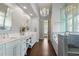 Elegant bathroom with a crystal chandelier, double vanity, and a glass-enclosed shower creating a spa-like retreat at 4465 Newhall Dr, Cumming, GA 30040