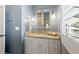 Stylish bathroom featuring a granite countertop vanity with a decorative mirror and light fixtures at 4465 Newhall Dr, Cumming, GA 30040