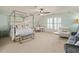 Bright bedroom featuring a stylish four-poster bed, desk, and seating area with natural light at 4465 Newhall Dr, Cumming, GA 30040