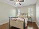 Simple bedroom featuring hardwood floors, ceiling fan, and a metal frame bed with a side table at 4465 Newhall Dr, Cumming, GA 30040