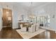 Elegant dining room with modern light fixture, exposed brick, and hardwood floors at 4465 Newhall Dr, Cumming, GA 30040