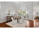 Bright dining room featuring modern chandelier, shuttered windows, and elegant decor at 4465 Newhall Dr, Cumming, GA 30040