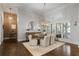 Elegant dining room with modern light fixture, exposed brick, and hardwood floors at 4465 Newhall Dr, Cumming, GA 30040