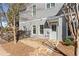 Exterior view of a gray home with a stone pathway, fenced yard, and a welcoming entrance at 4465 Newhall Dr, Cumming, GA 30040