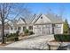 Charming two-story home with a three-car garage and welcoming covered porch at 4465 Newhall Dr, Cumming, GA 30040