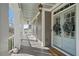 Welcoming front porch with double doors, hanging lanterns, and inviting seating area at 4465 Newhall Dr, Cumming, GA 30040