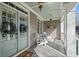 Cozy front porch featuring double doors, hanging lanterns, and seating at 4465 Newhall Dr, Cumming, GA 30040