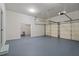 Spacious two car garage with light gray epoxy floors, automatic garage door openers, and a large storage area at 4465 Newhall Dr, Cumming, GA 30040
