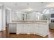 Bright kitchen featuring white cabinetry, stainless steel appliances, and hardwood floors at 4465 Newhall Dr, Cumming, GA 30040