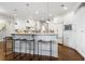 Spacious kitchen featuring a breakfast bar, white cabinets, and hardwood floors at 4465 Newhall Dr, Cumming, GA 30040